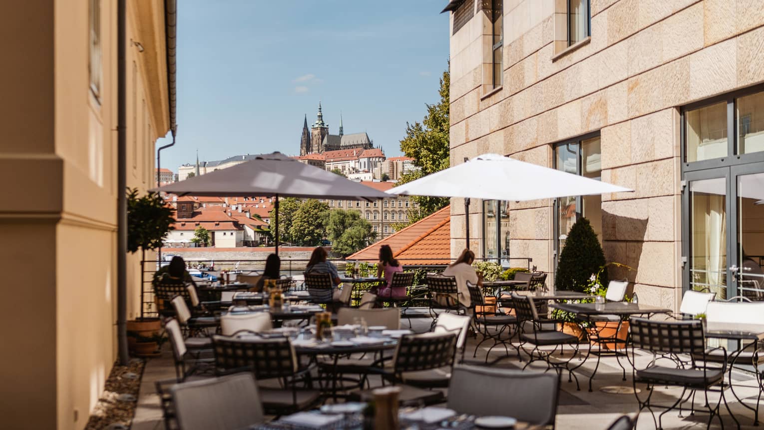 Rooftop terrace with wrought iron tables and market umbrellas