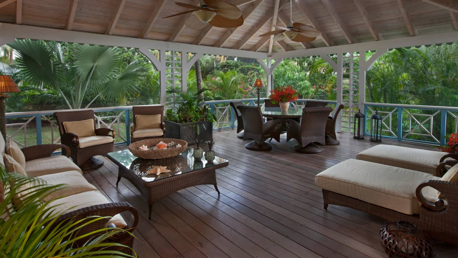 Palm Grove Residence patio, wicker furniture under soaring wood ceilings, fans