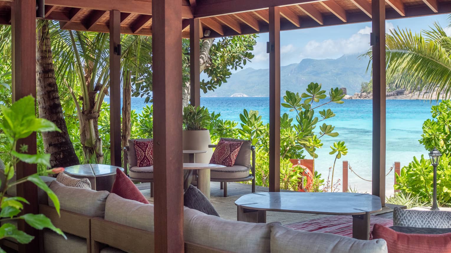 Lounge area set underneath a pavilion and looking out to tropical sea view