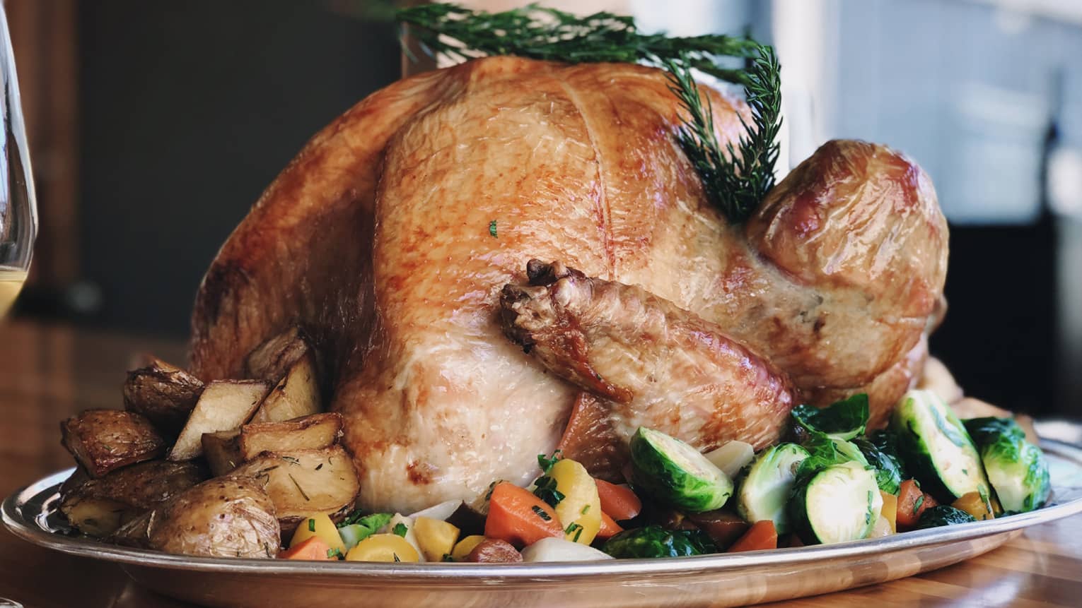 ,A cooked turkey in a large metal tray.