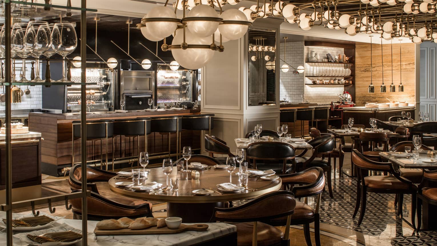 The interior of a dining outlet with many hanging lights, various tables, and a bar.