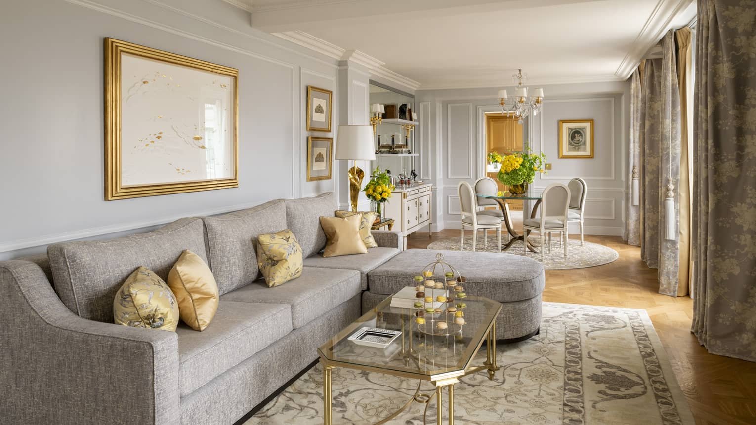 Living room with grey sectional sofa and dining table with four chairs