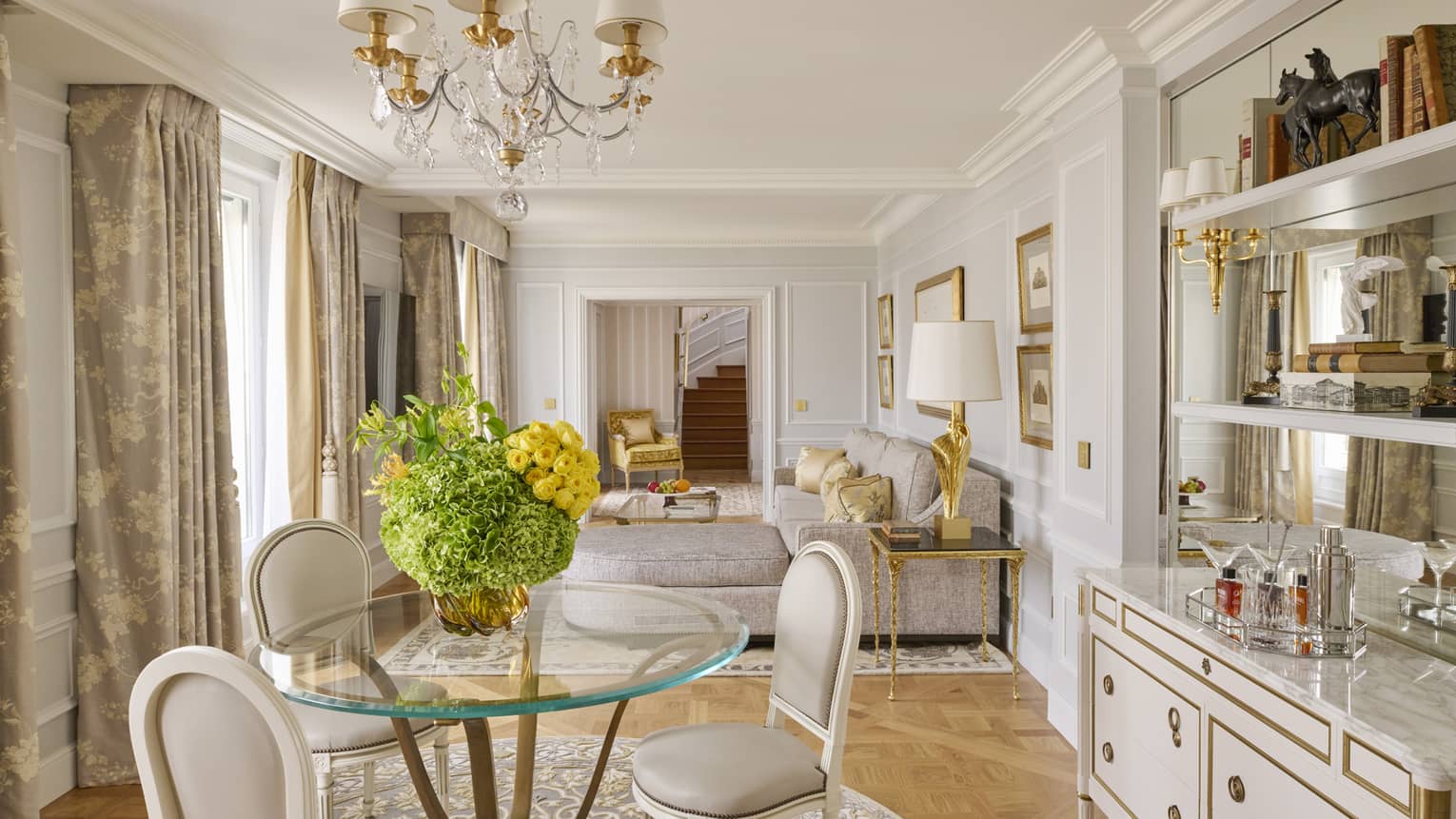 Round dining table and four upholstered chairs and elegant buffet