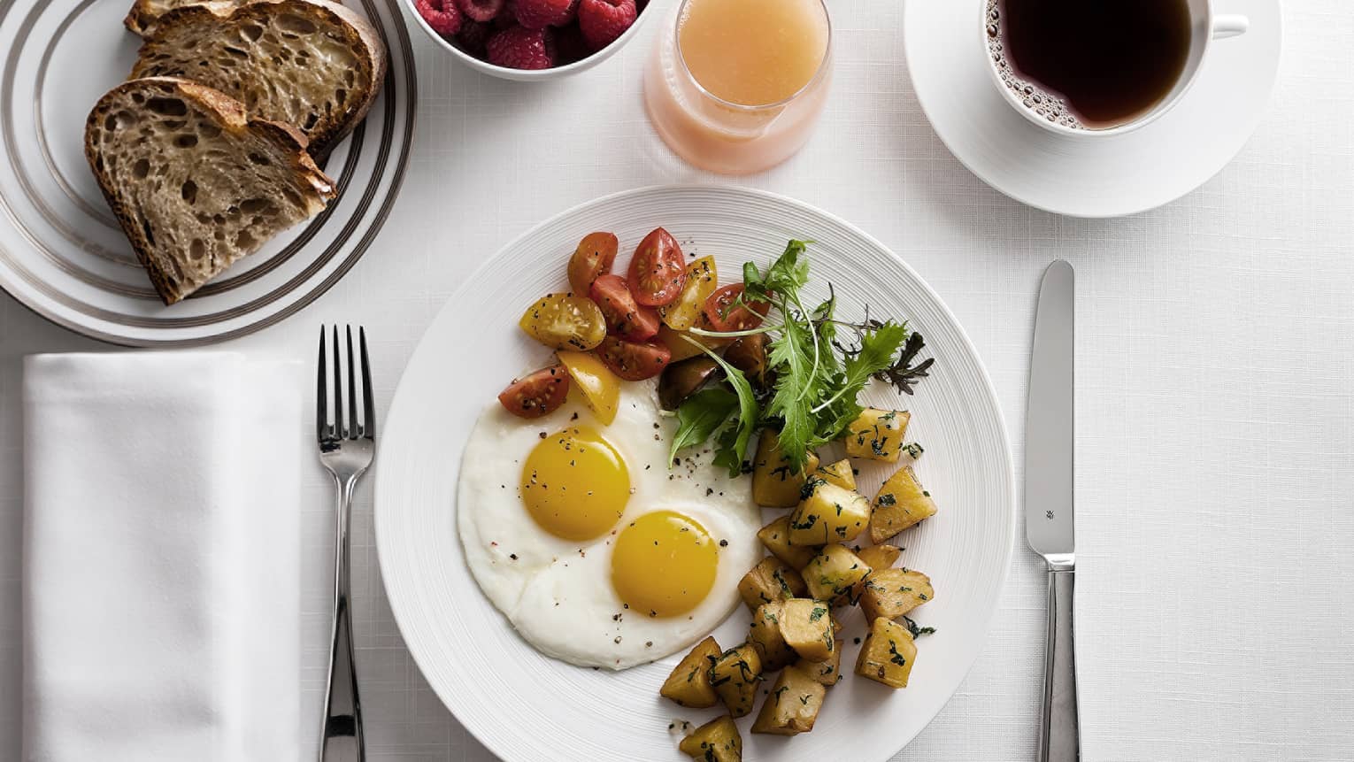 In-bungalow dining breakfast with sunny side egg, roast potatoes and salad, toast, coffee and fresh fruit