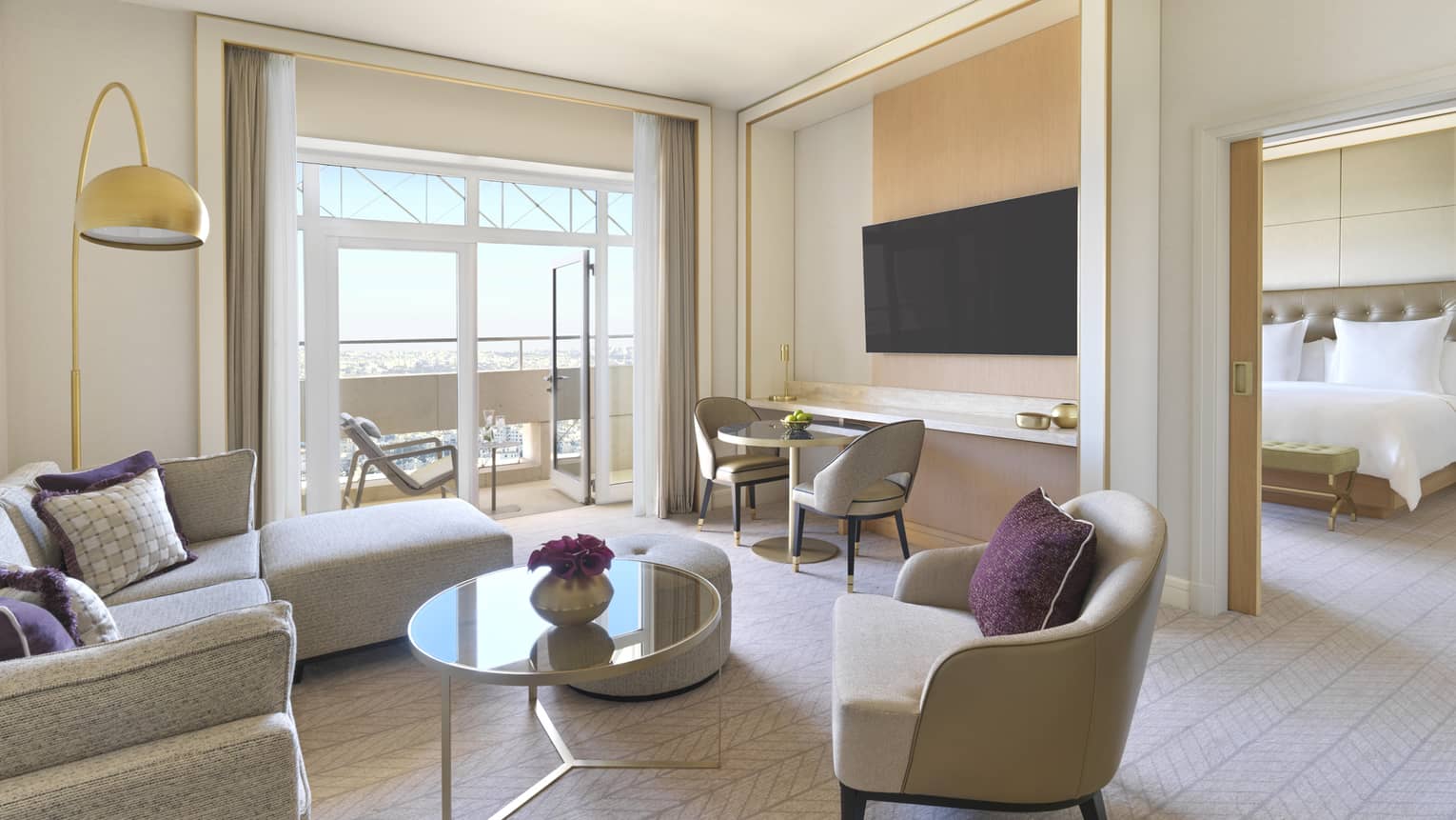 A spacious room with an L-shaped couch and several plush chairs overlooking the Amman skyline