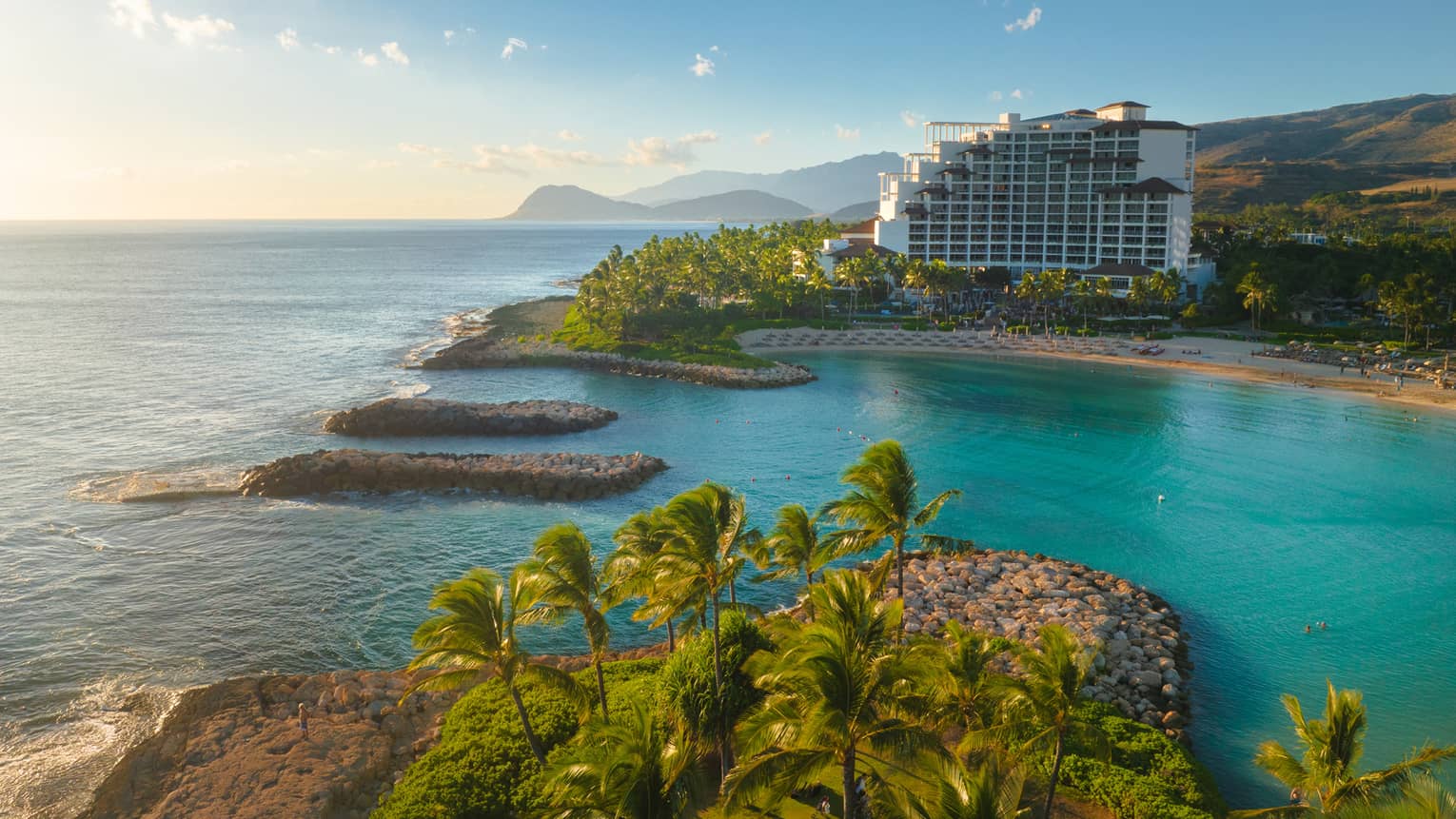 Resort building set on a turquoise lagoon on Hawaiian island