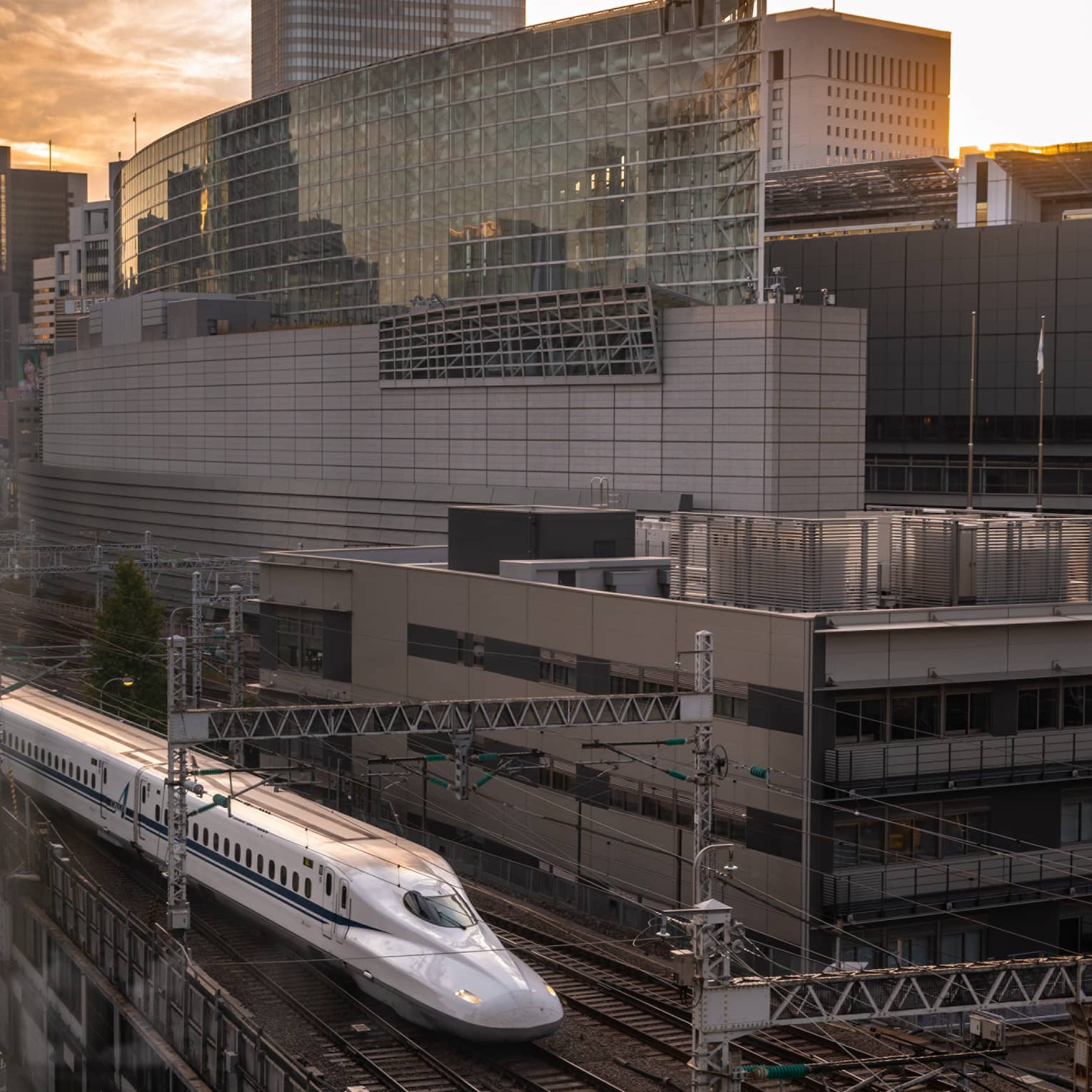 Shinkansen bullet train arrives at the station at sunset