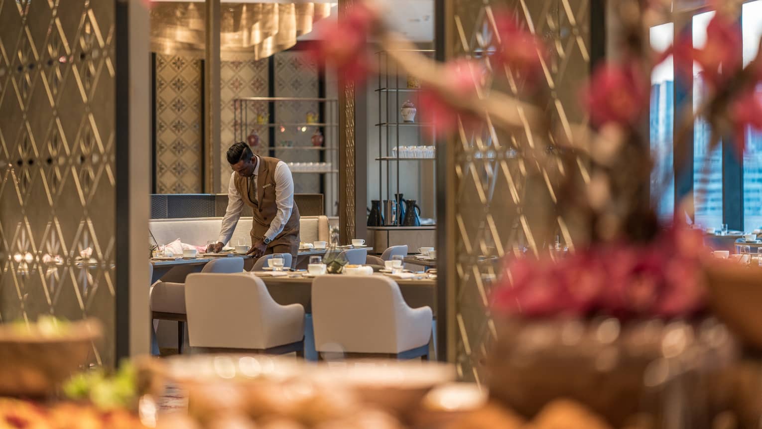 Curate server arranges dishes in the dining area