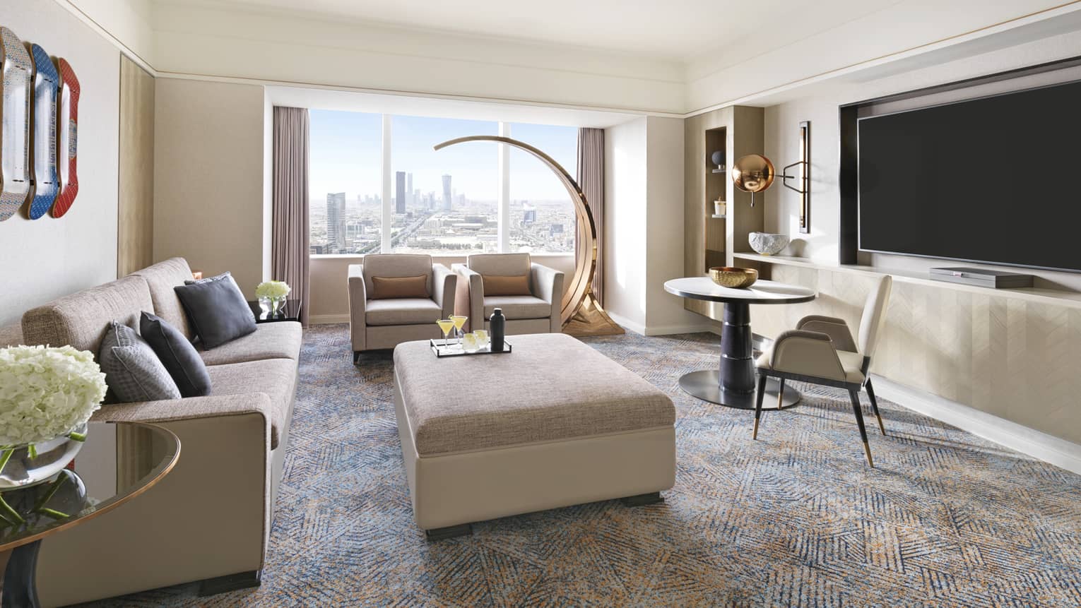 Living room with window, two sofas, matching ottoman/table and TV