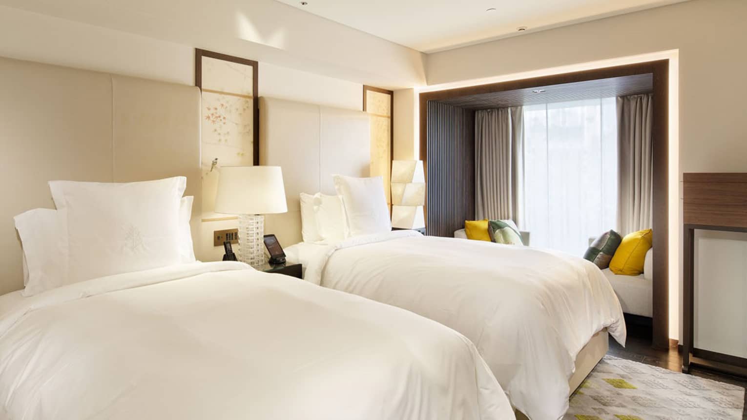 Bedroom with two twin beds and bench built into the windowside