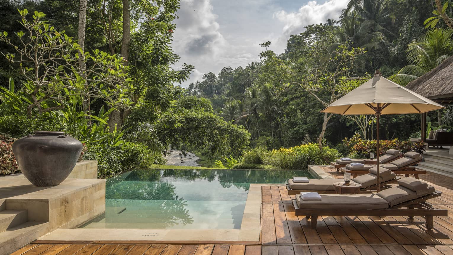 A relaxing villa with an infinity pool overlooking a river in Bali