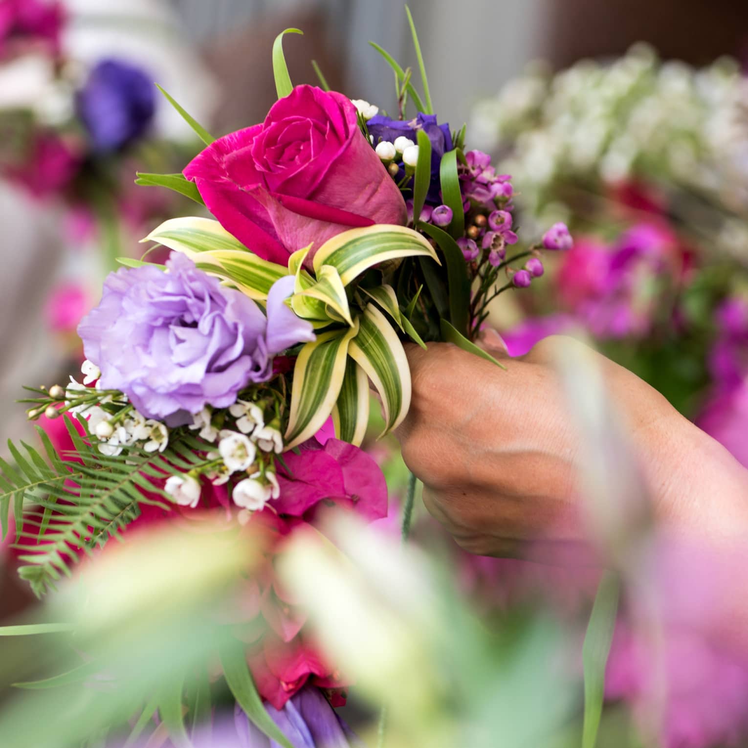 Lei making with bright flowers