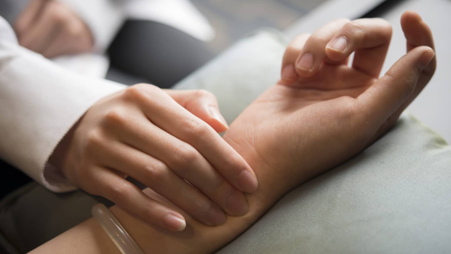 Hand placed on wrist in spa