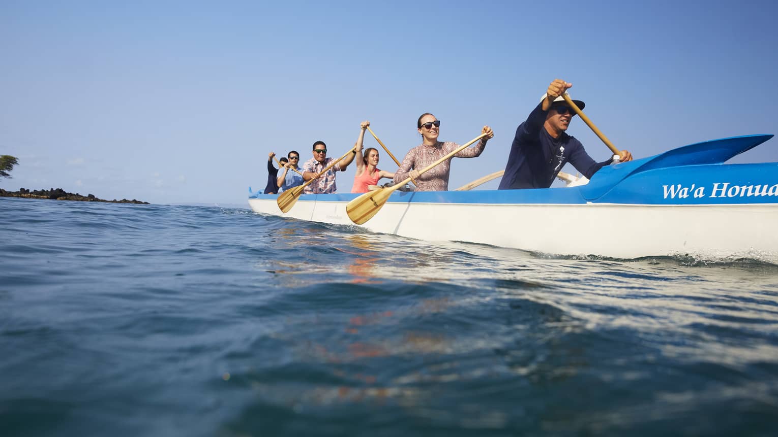 A group of guests kayaking on the ocean