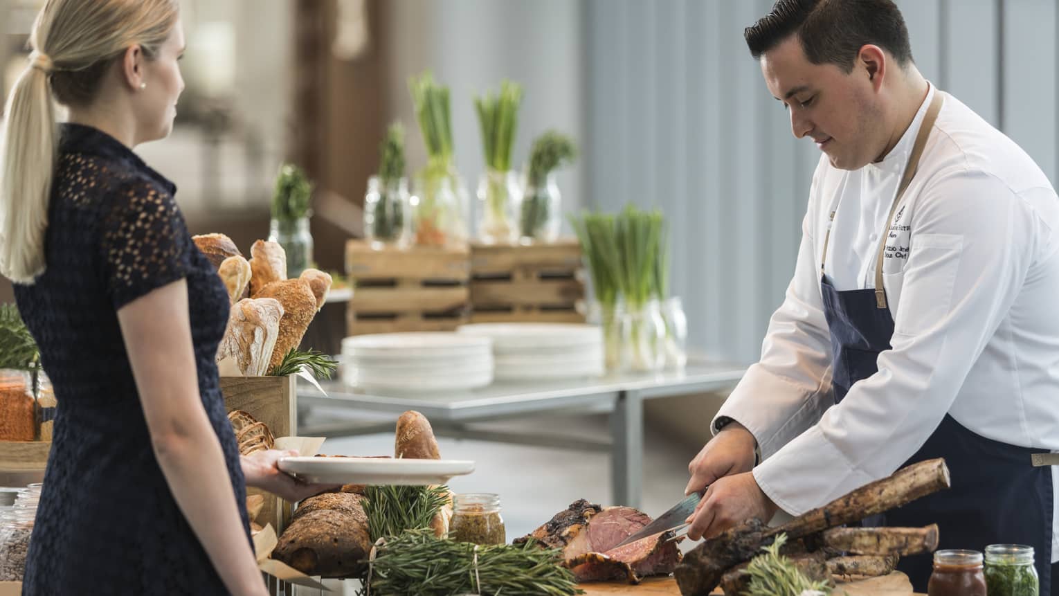 A chef cutting steak for a guest at the Sky Bridge