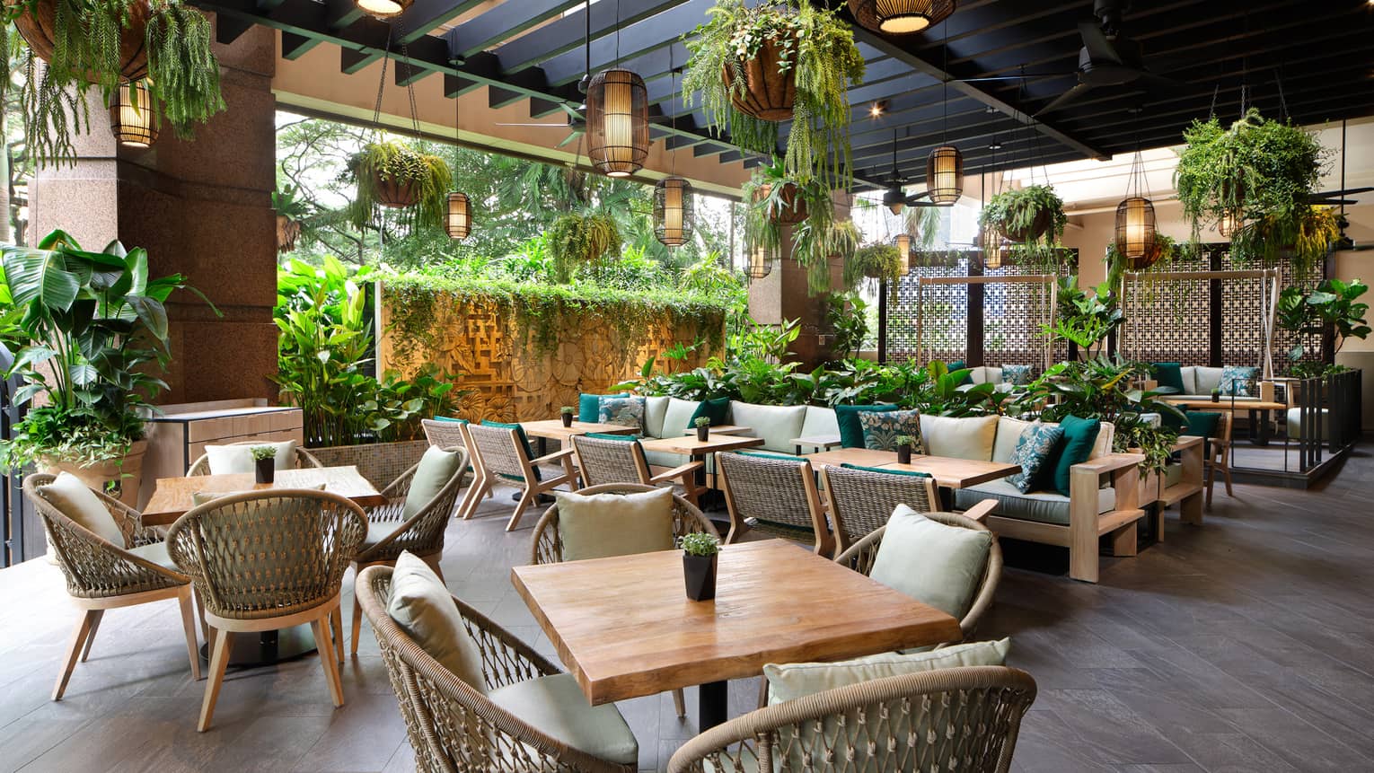 Garden@One-Ninety outdoor lounge with rattan chairs, square tables for four, portico ceiling, hanging plants and lighting