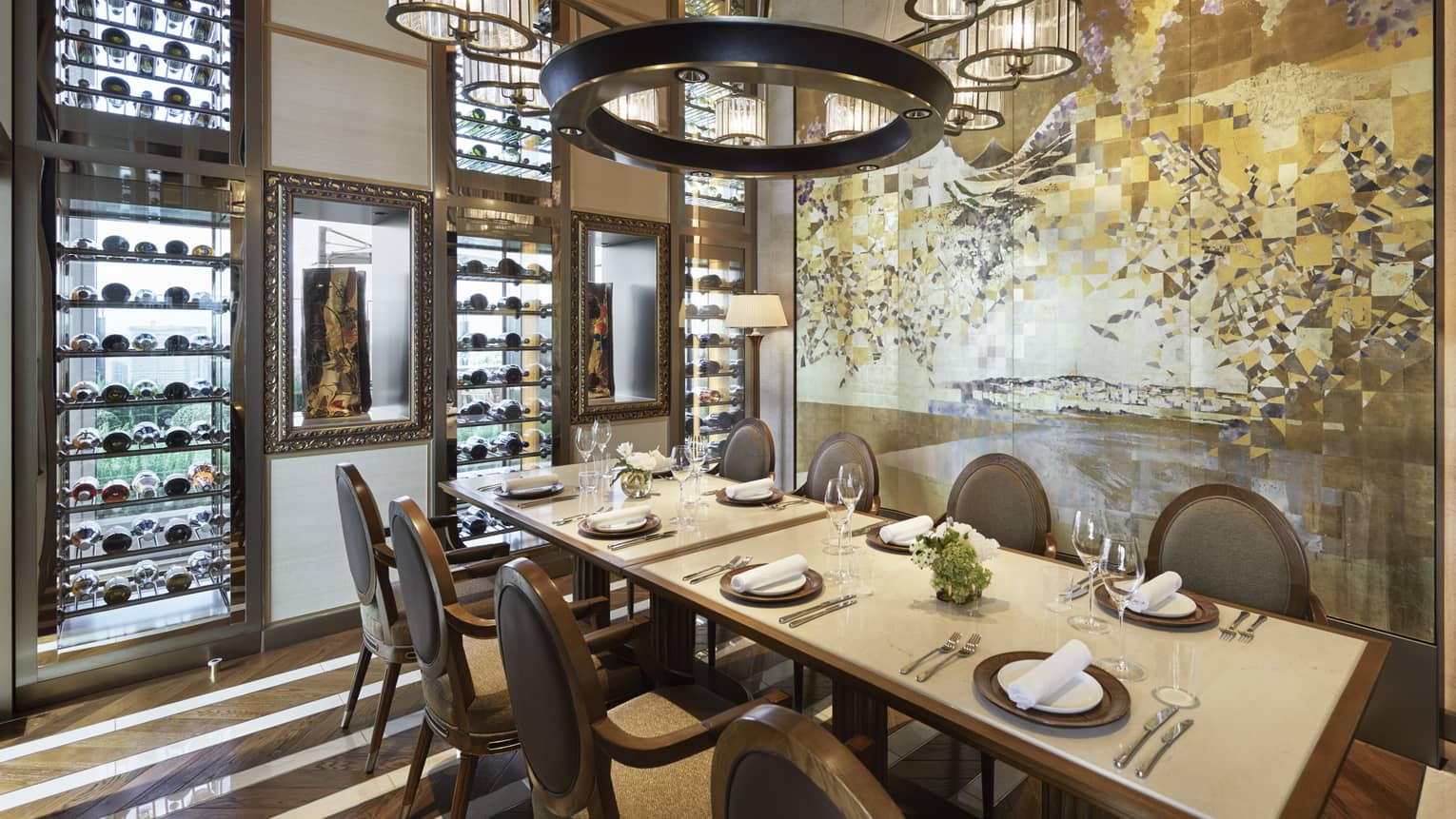 Est dining room with table set for eight, muted cream decor, circular chandelier, hardwood floors