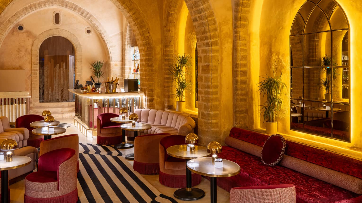 Indoor lounge with stone archways and stylish black-and-white striped tile floor