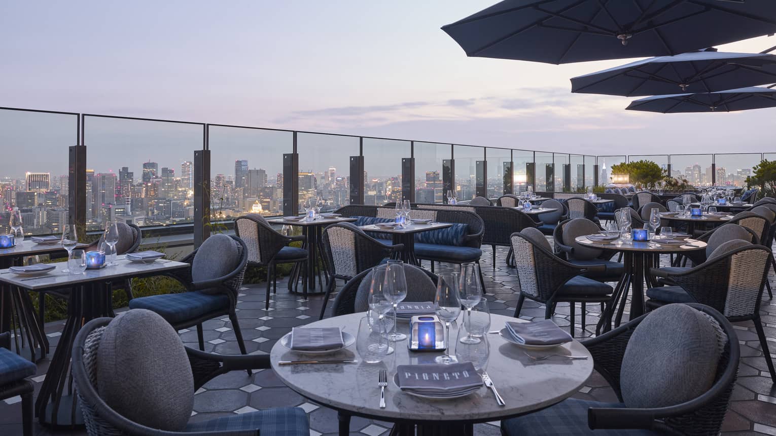Four Seasons rooftop restaurant with a city skyline views at dusk