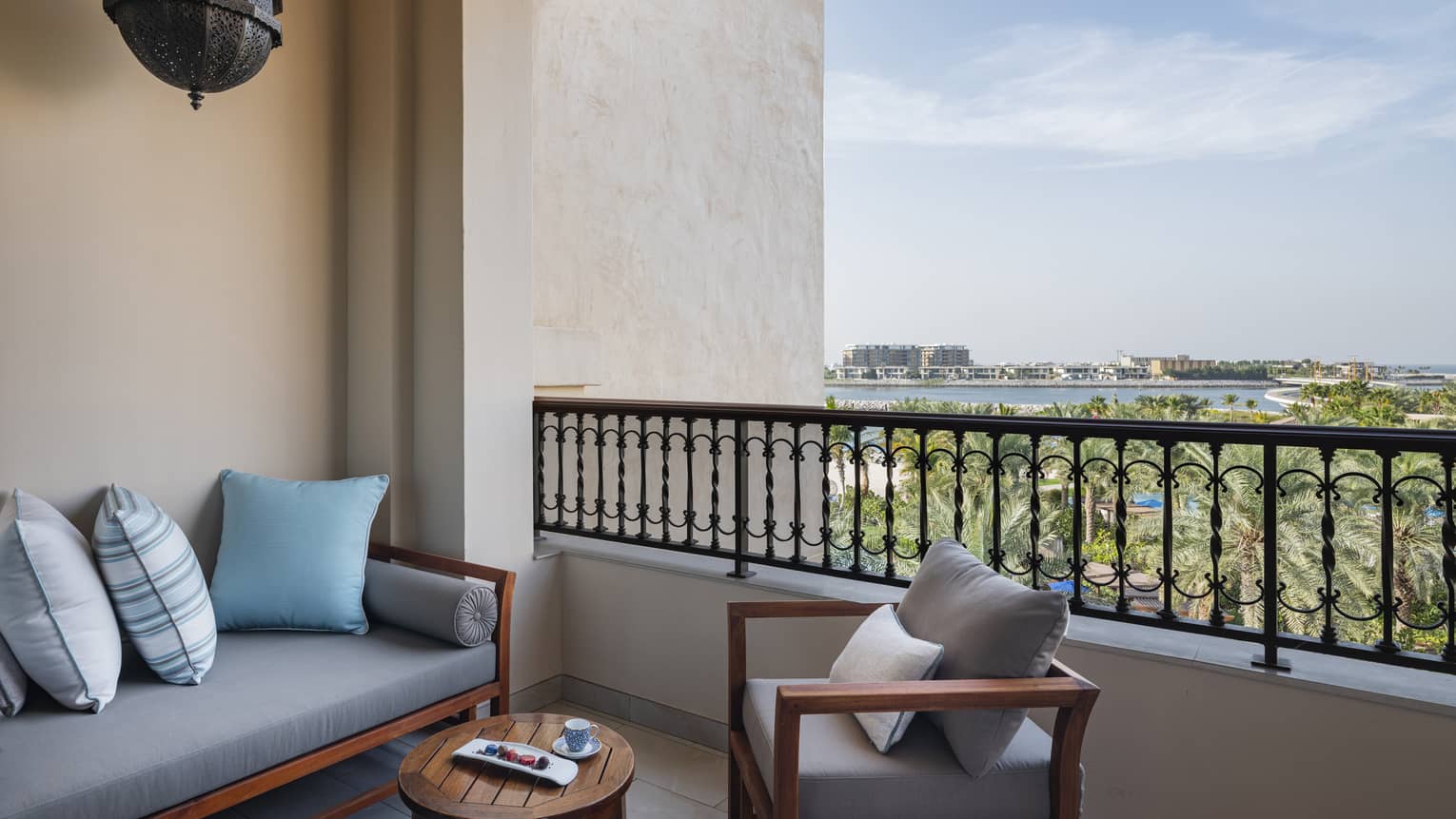 Private covered terrace of a hotel suite, with daybed and arm chair