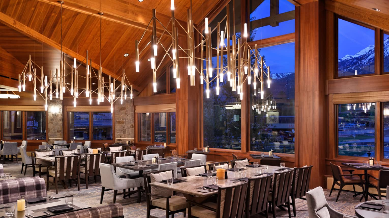 Empty dining room, wooden ceiling and exposed beams, bright chandeliers