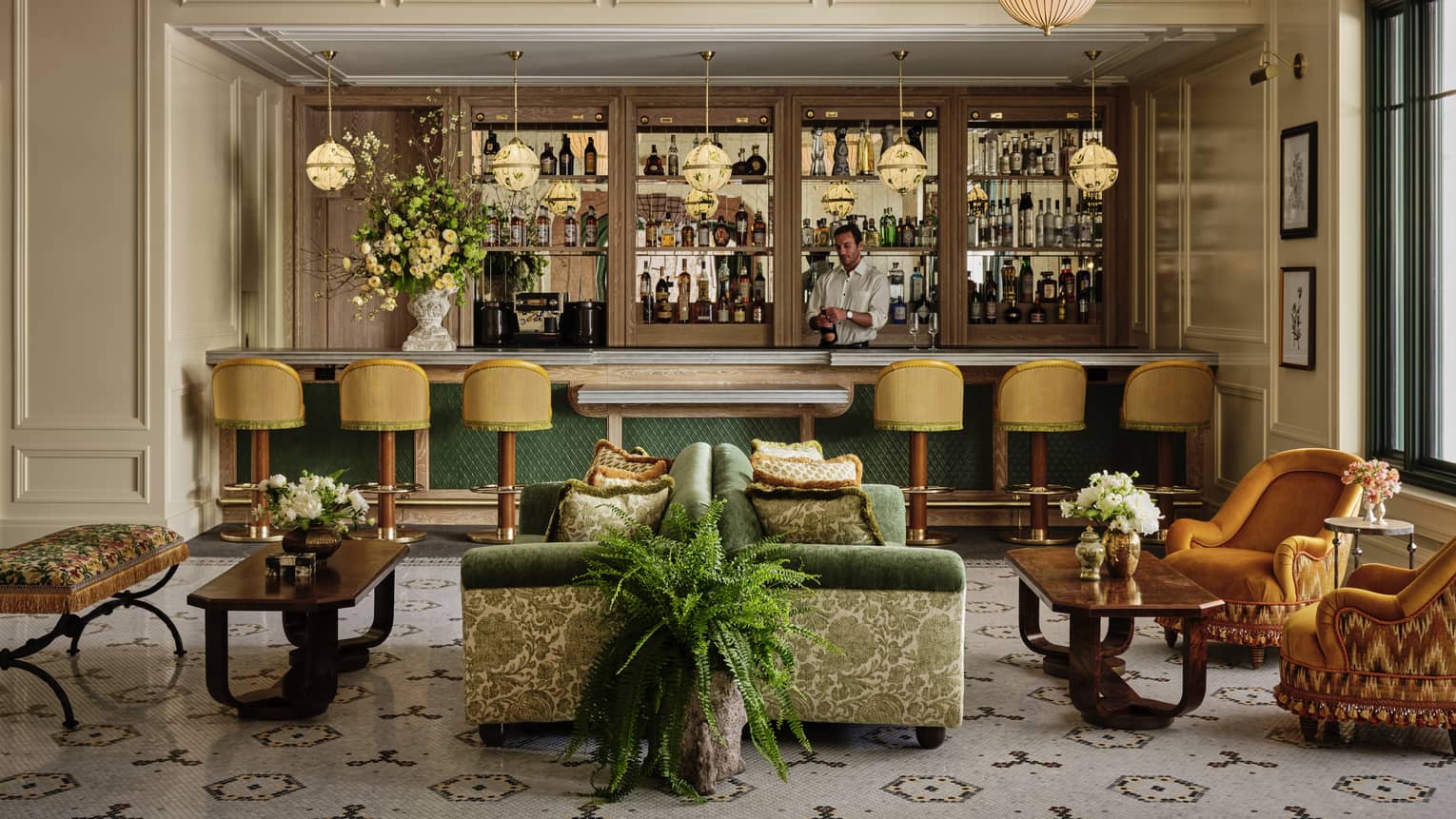 A bar area with colourful seats and plants.