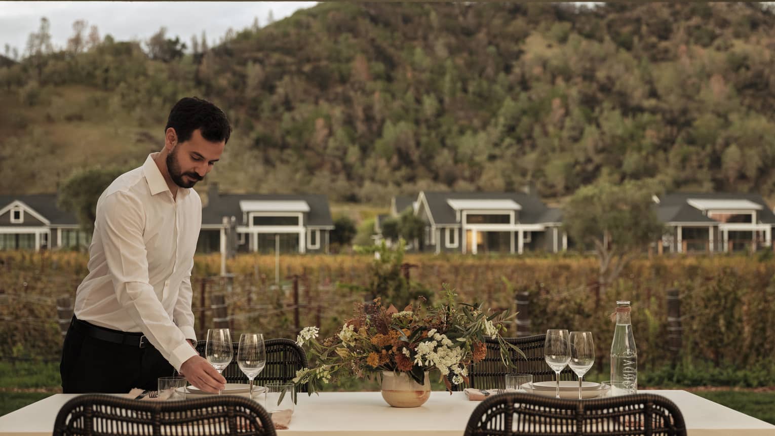 Staff setting up outdoor dinner