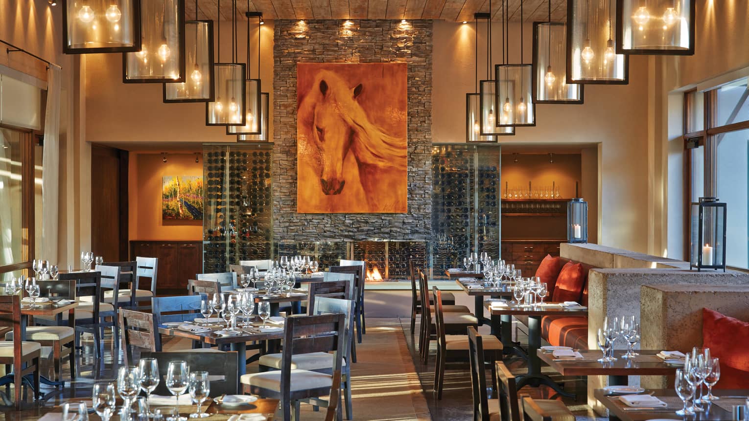 Large horse painting over stone fireplace, Terra dining tables, chairs