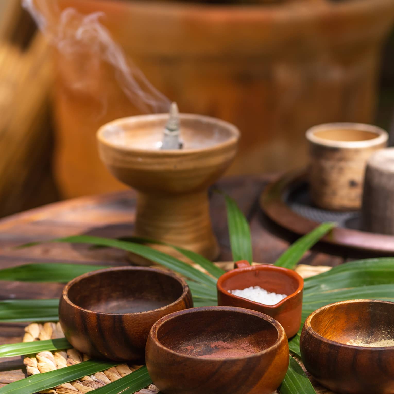 A candle or incense burning above spa minerals.