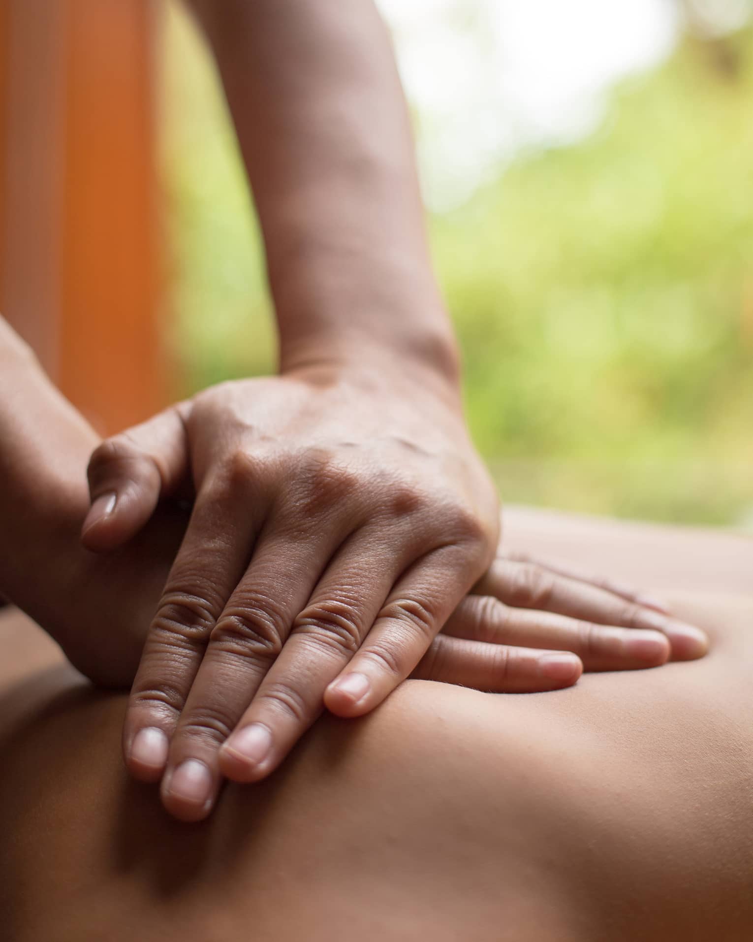 Close up of hands massaging a back