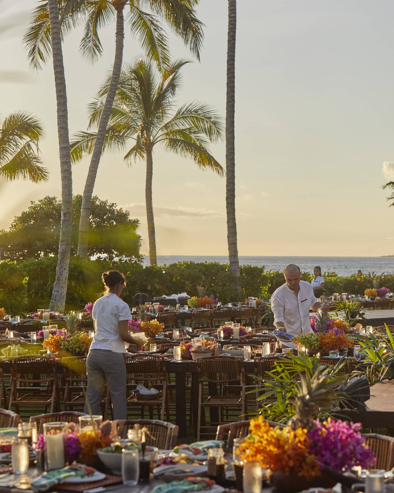 Four Seasons staff setting tables outside of Four Seasons Hawaii, Oahu at Ko Olinaat a Luau Dinner