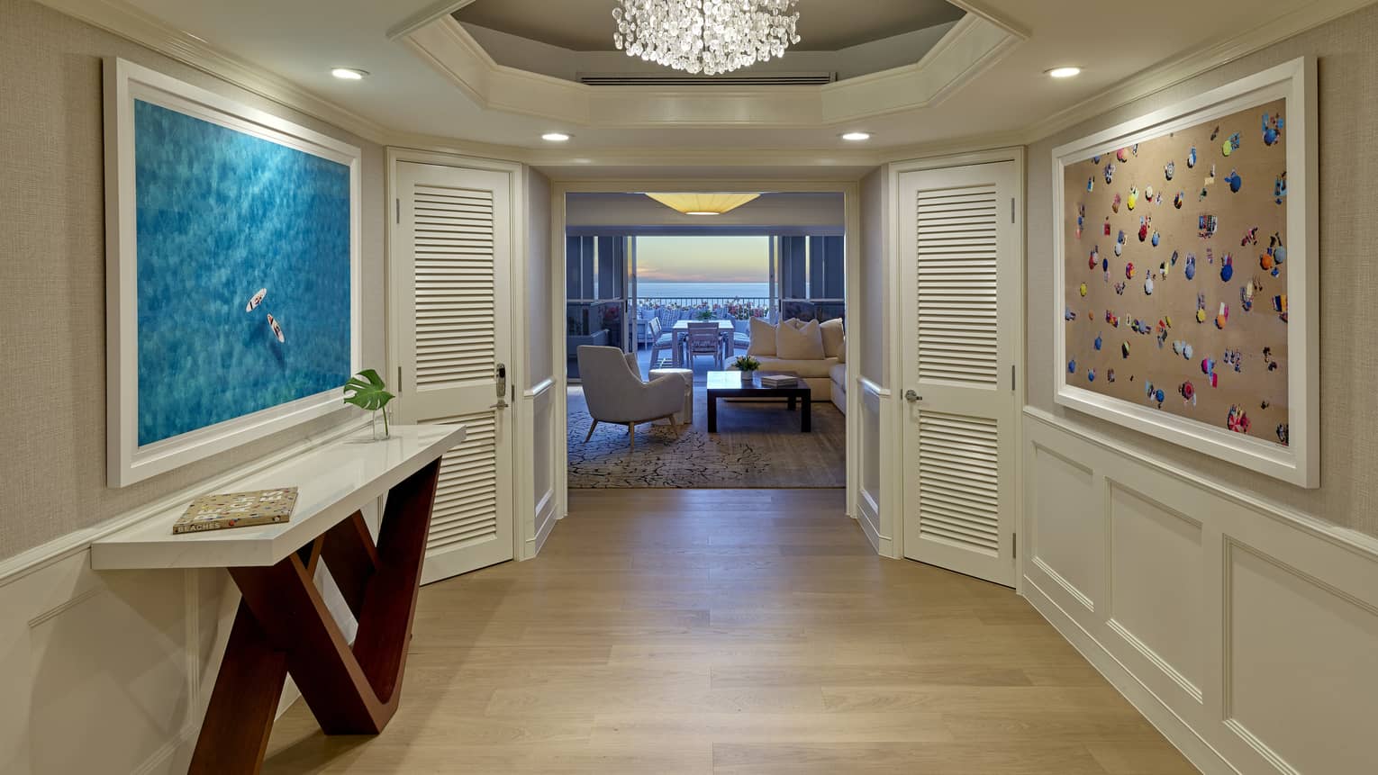 Hallway with chandelier, sideboard, artwork