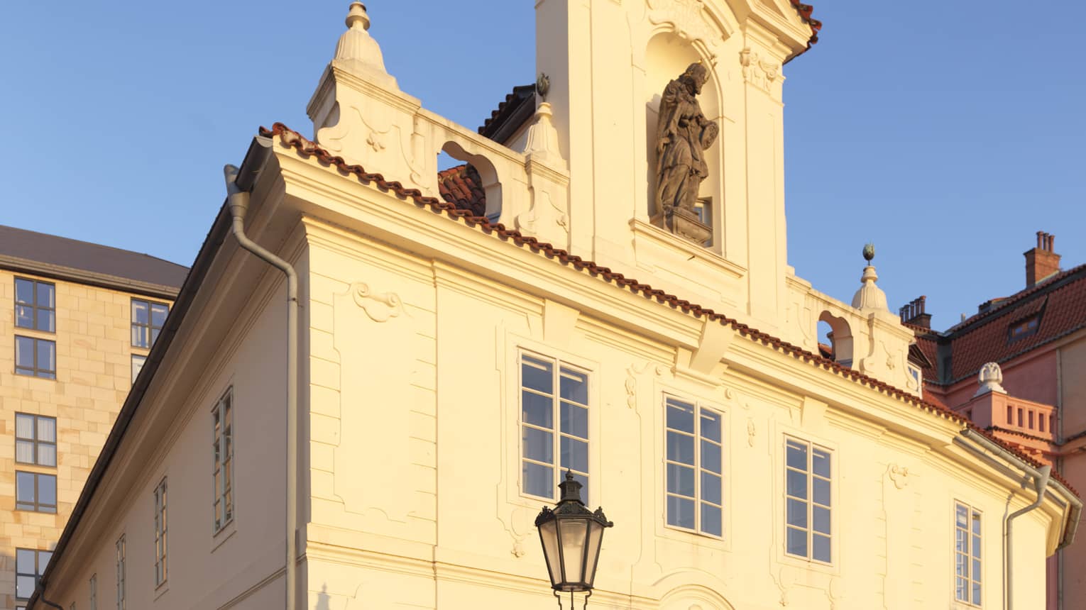 Sun shines on historic Barogue Building against blue sky