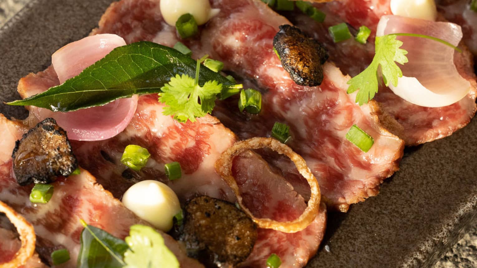 Thinly sliced Wagyu beef tataki topped with coriander leaves