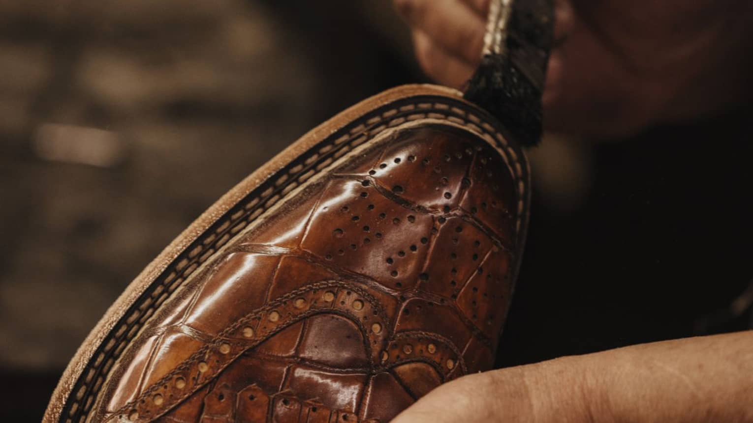 Paintbrush on brown leather shoe.