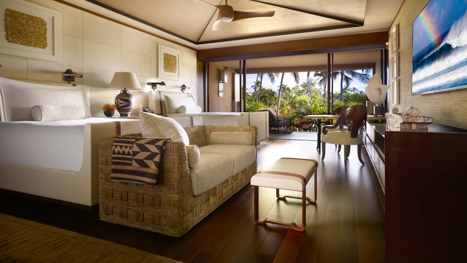 Garden-View Room bed, wicker sofa with white cushions, bench at foot, open wall to patio