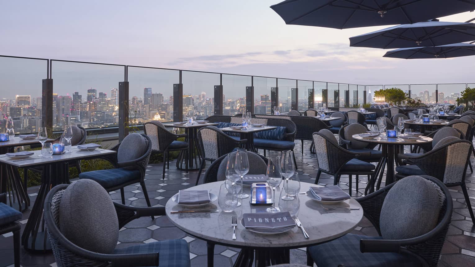 Four Seasons rooftop restaurant with a city skyline views at dusk