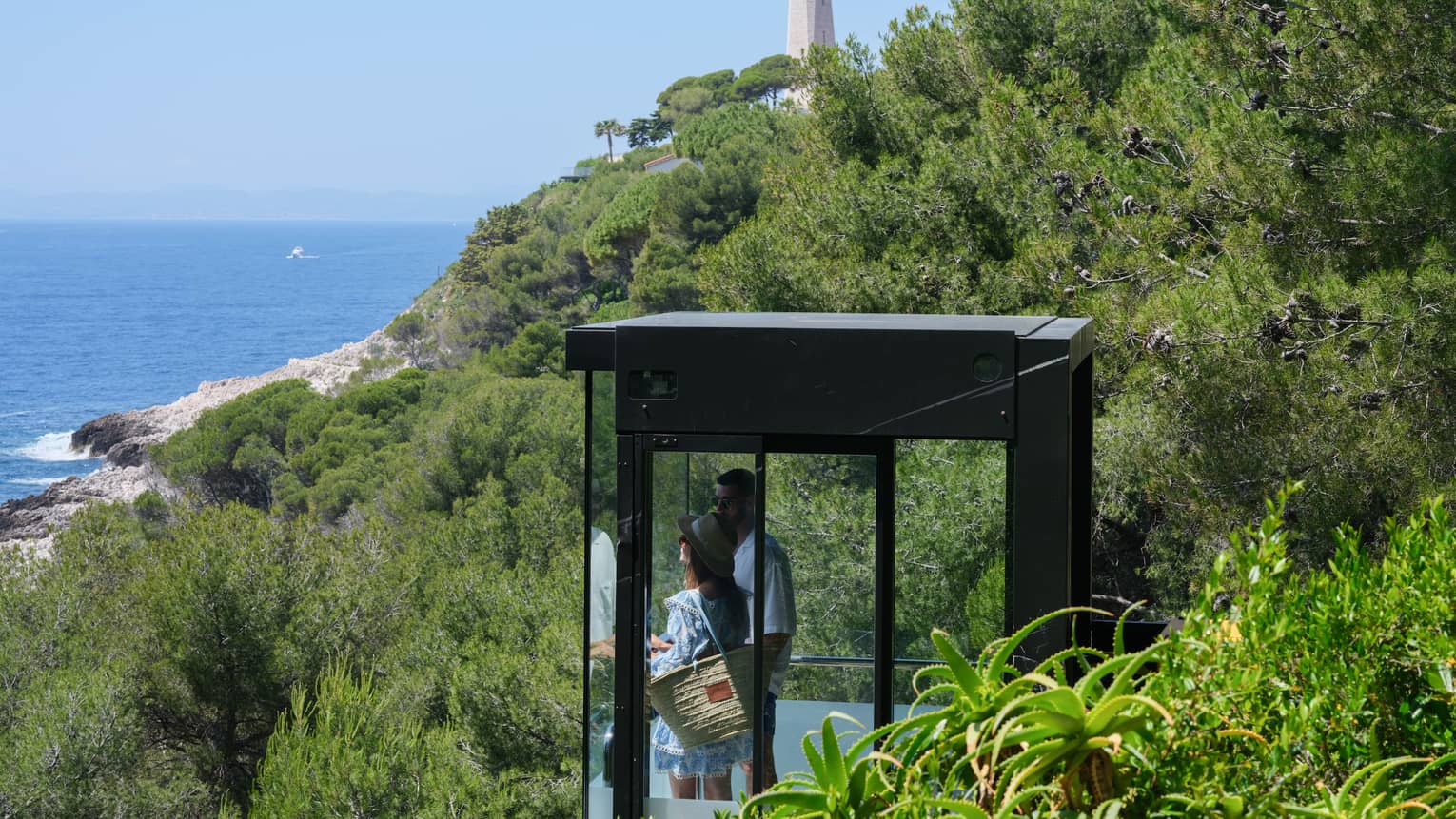 A couple admiring the sea view from the glass funicular at Club Dauphin