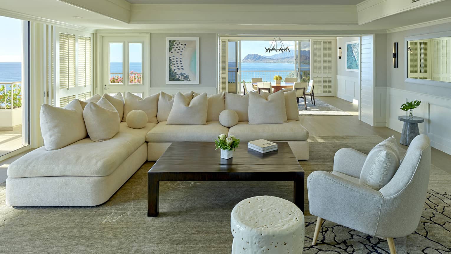 Living room with cream sectional sofa, grey arm chair, square table