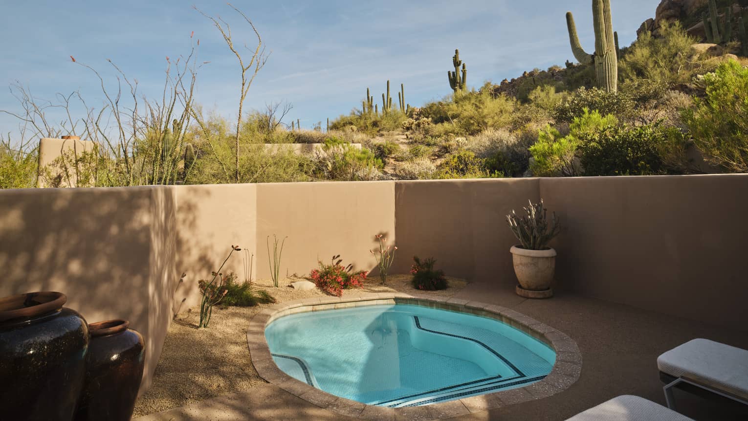 Private plunge pool on a walled-in terrace with desert views