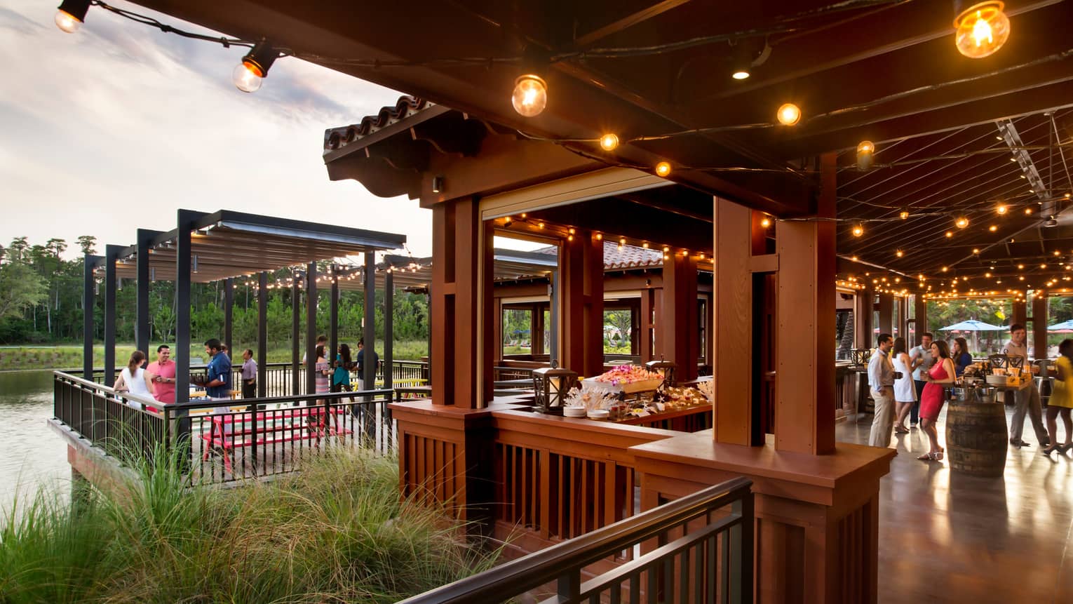 PB and G restaurant, people socializing under covered wood patio with lights