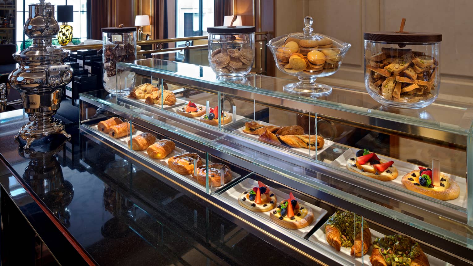 Close-up of bakery counter display case with fresh pastries, cookies, tarts