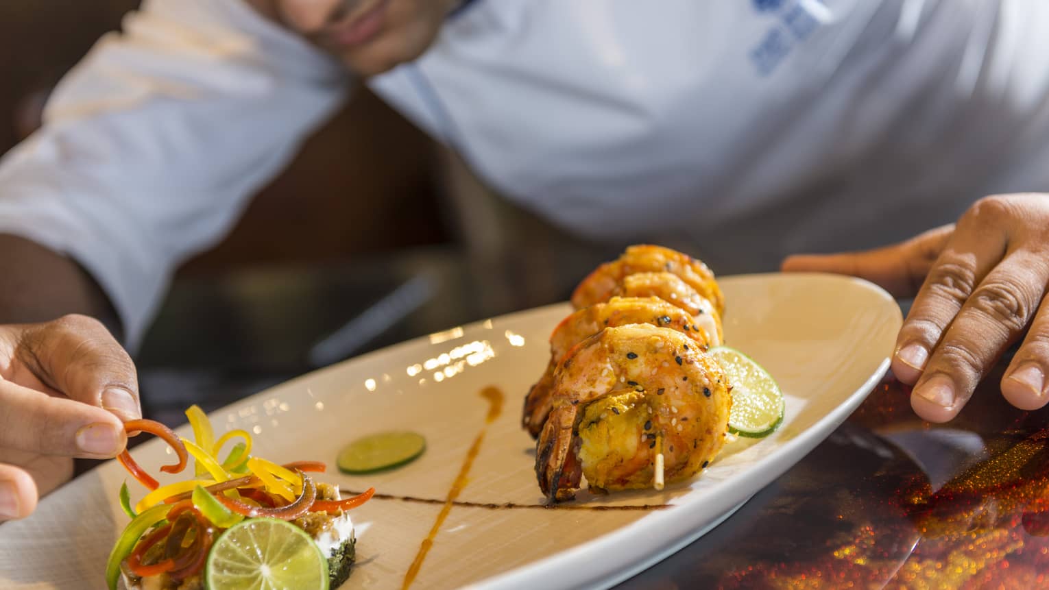 A chef plates some Baraabaru - Malabar Prawns