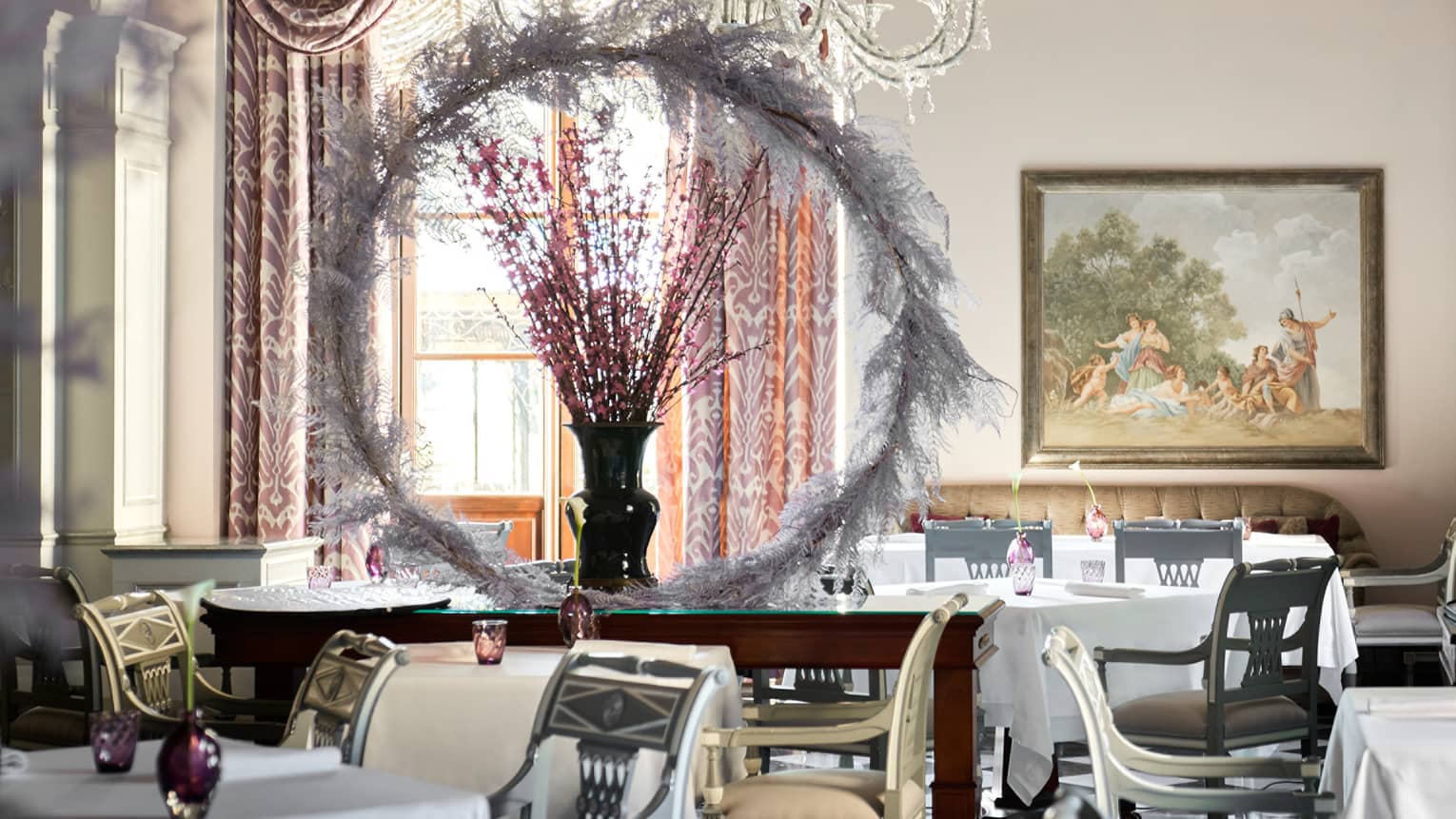 A dining outlet with large wood tables, and many chairs.