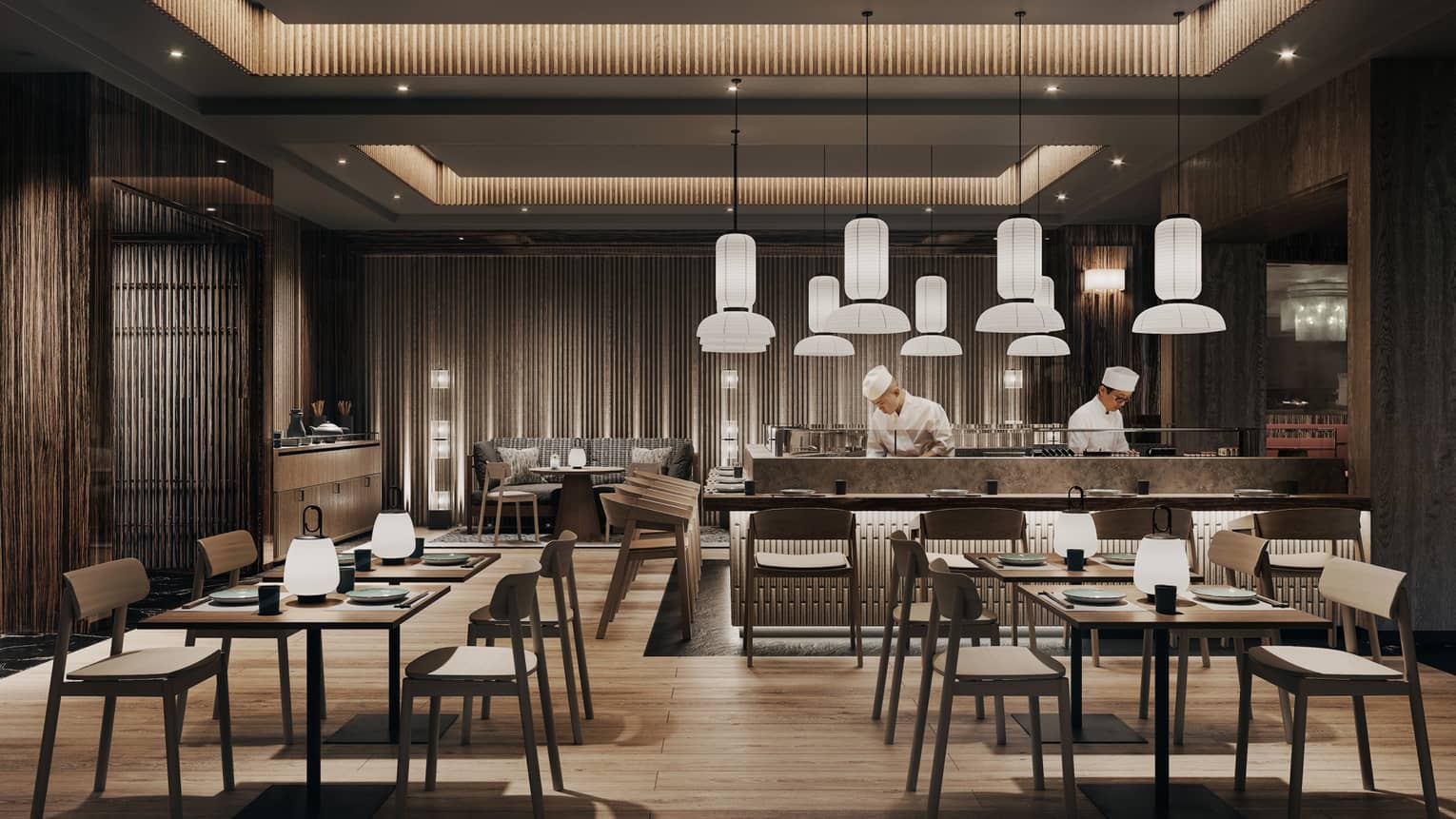 A dining area with several square tables, all set up around a sushi prep station.