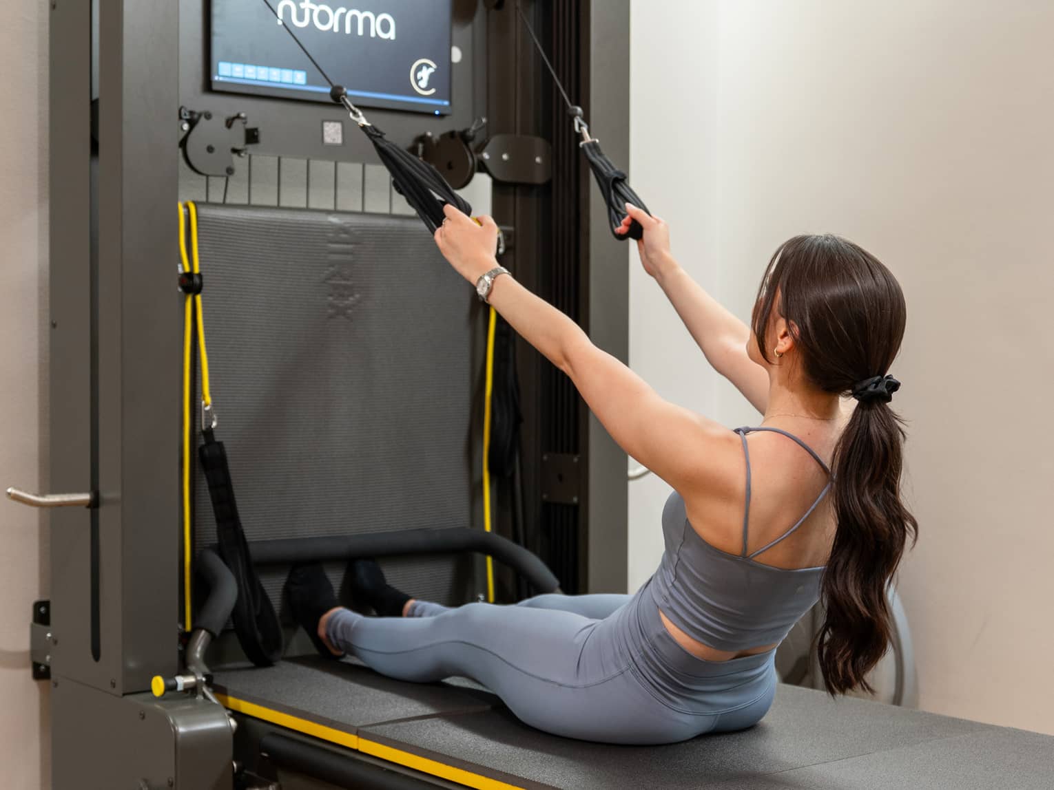 A woman exercises on a nforma machine