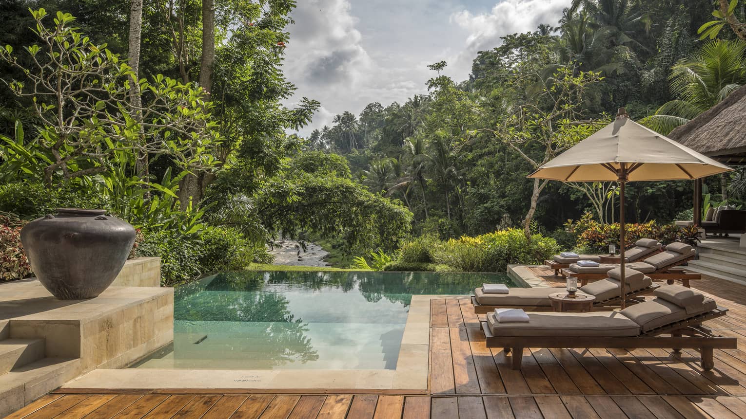 A relaxing villa with an infinity pool overlooking a river in Bali