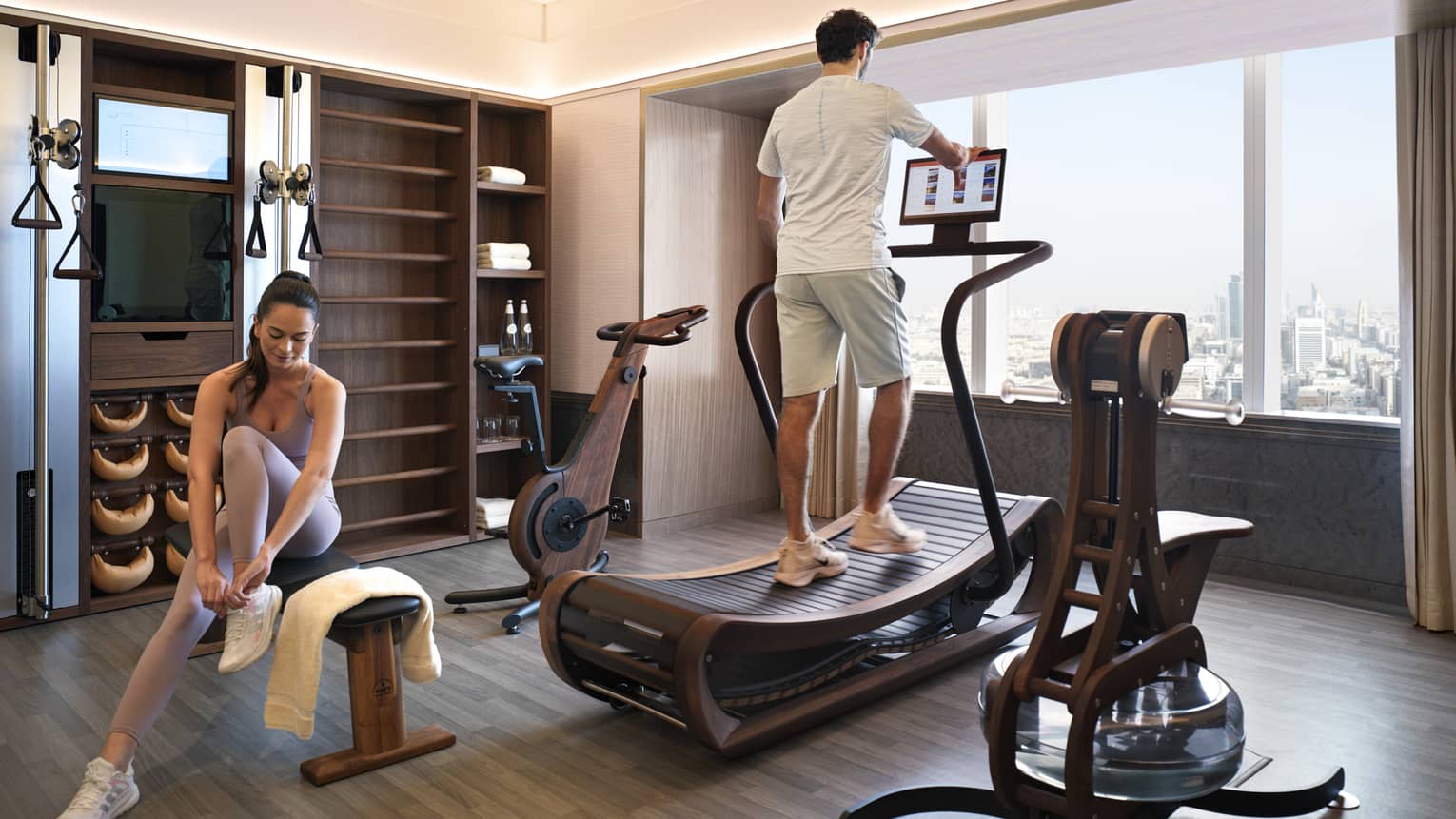 Man and woman work out in their en-suite fitness room