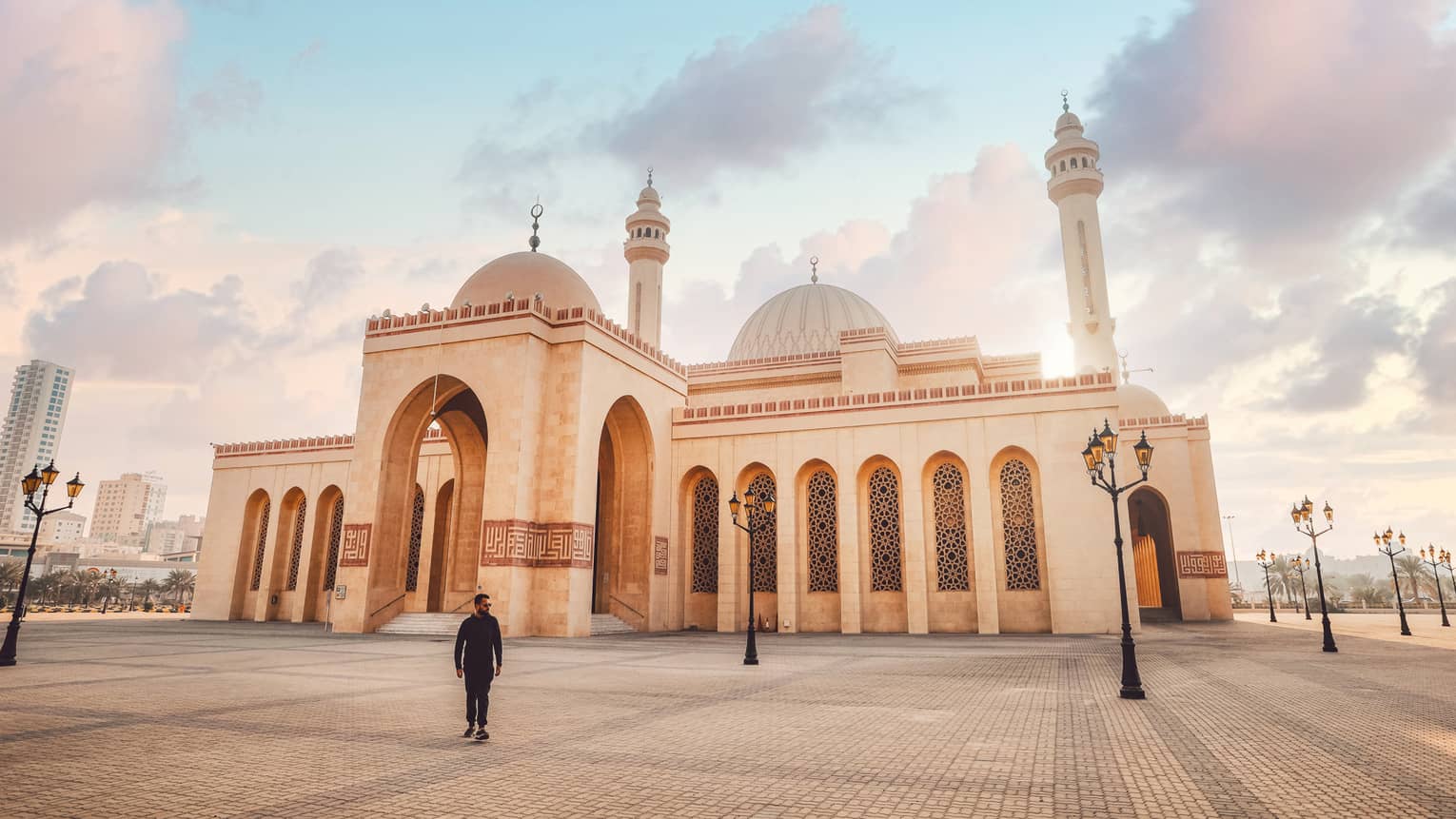 A large tan mosque with several pillars.