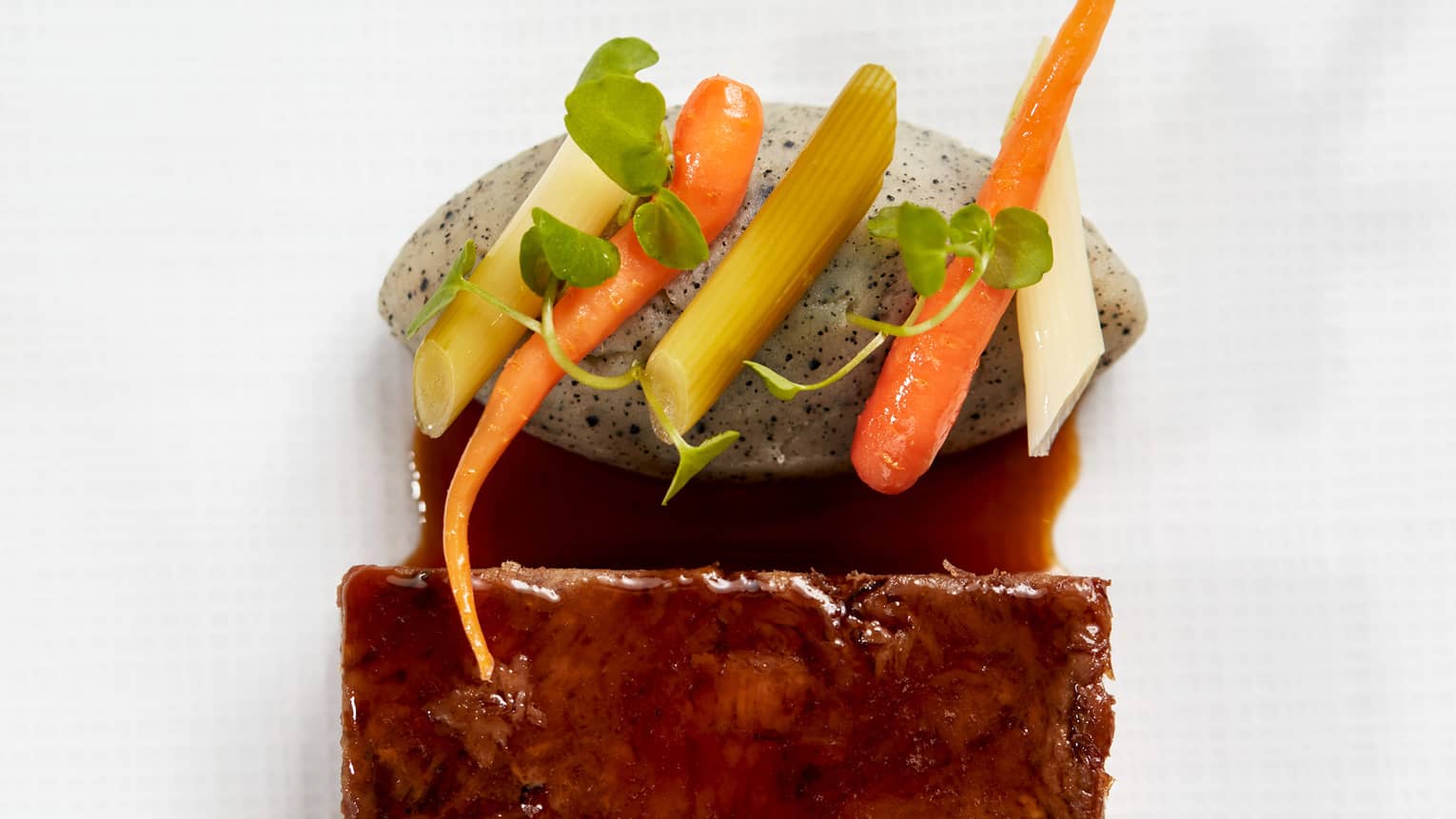 Lamb with pickles, mashed potatoes and a green sauce.
